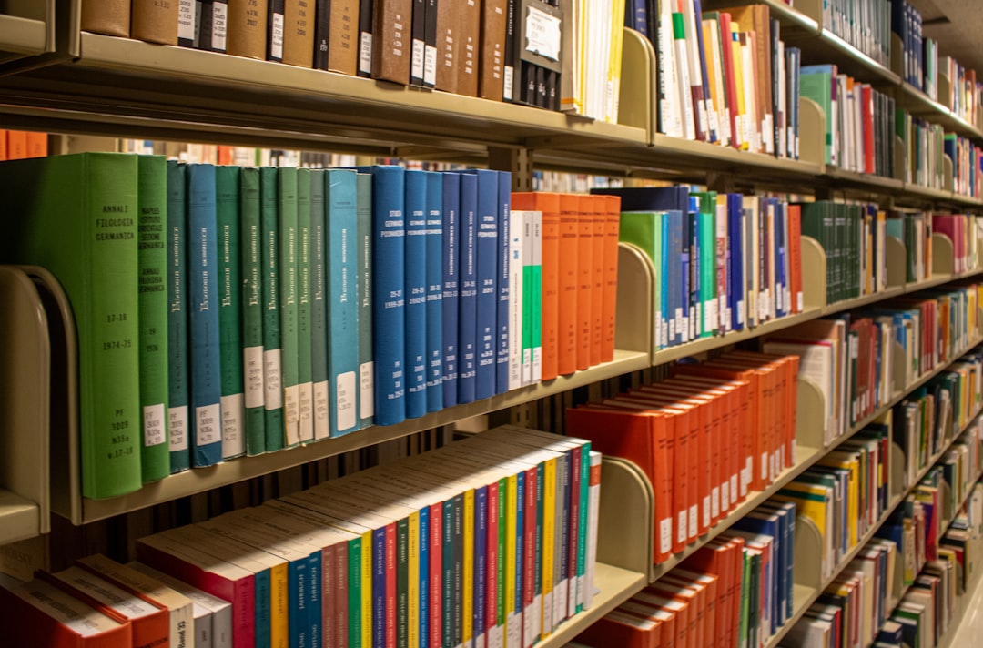 bookshelves are filled with colorful books in a library citation management tools research