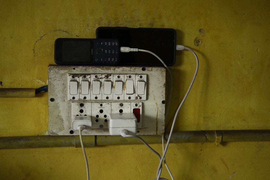 phones are charging on an electrical outlet remote control code entry electronics setup