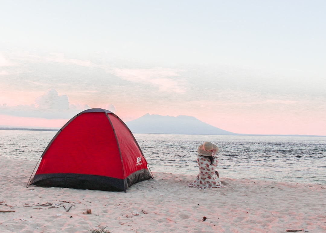 red and black dome tent near seashore couple travel beach backpacking mountains travel site interface
