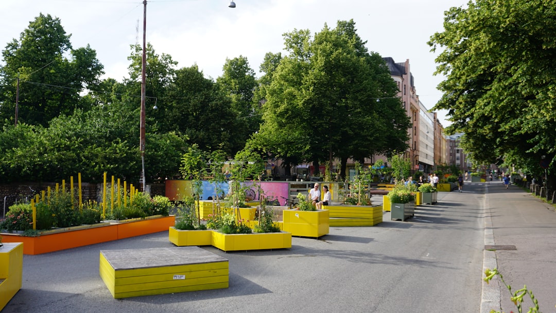 urban street with colorful planters and trees green spaces public parks eco friendly city