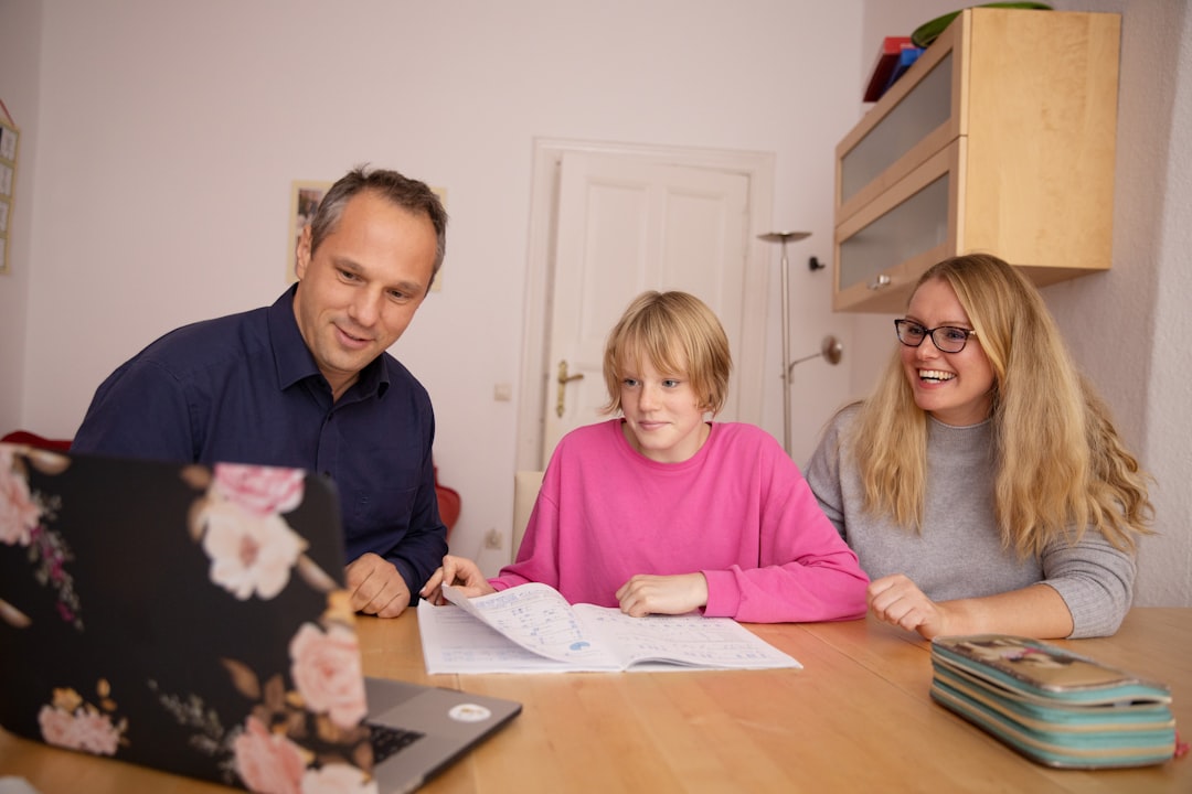 woman in blue shirt beside girl in pink shirt parent teaching teen finance credit building family budgeting