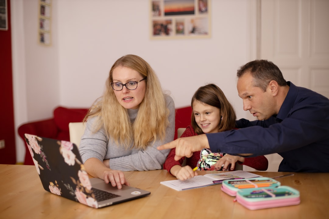 woman in gray long sleeve shirt sitting beside boy in blue sweater happy family using computer kids internet safety technology fun 1