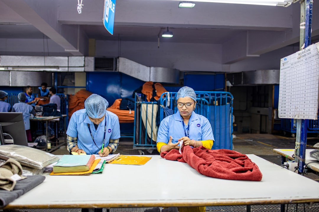 workers are processing items in a laundry facility factory workers tote bag production quality control 1