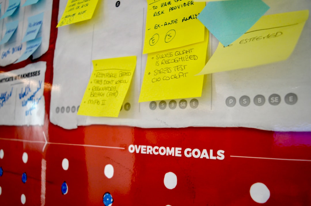 yellow sticky notes on white and red polka dot textile goal setting productivity worksheet business planning