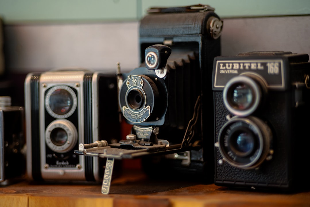 a couple of old cameras sitting on top of a wooden table vhs restoration family footage ai video upscale