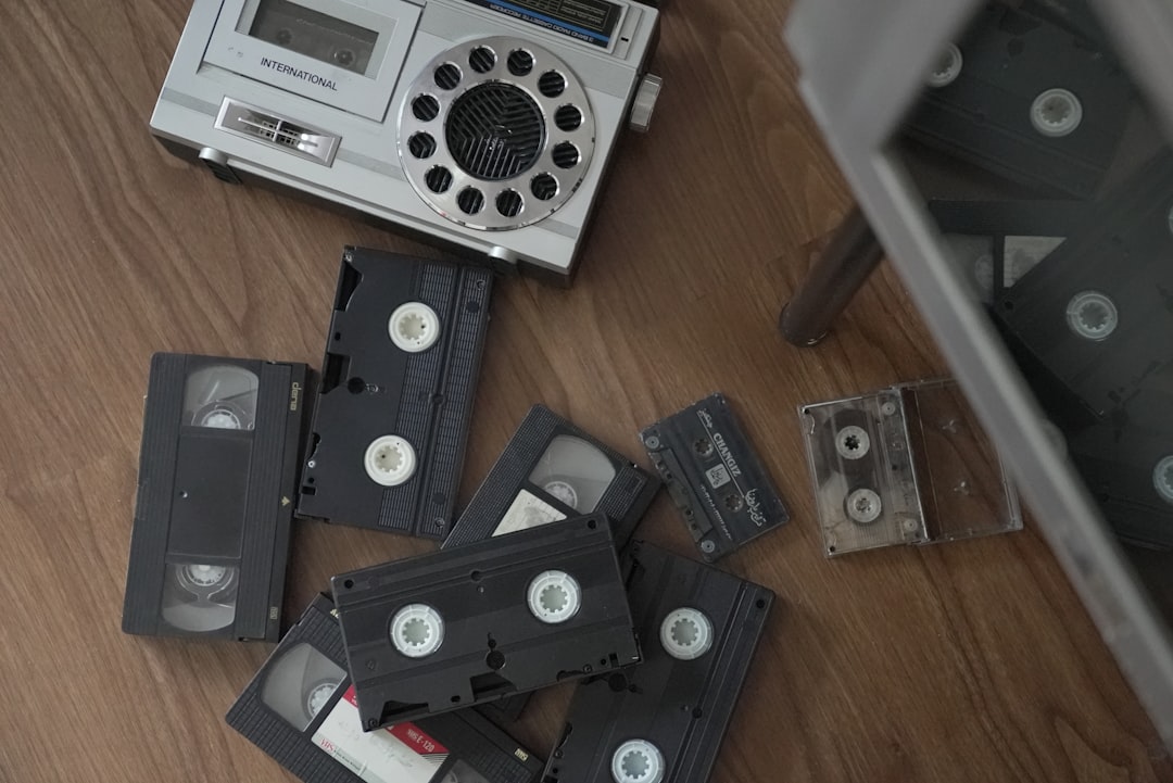 a pile of old tape recorders sitting on top of a wooden floor vhs restoration family footage ai video upscale