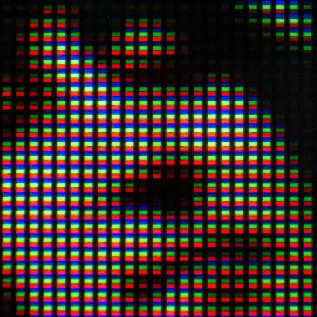 close up of a digital screen showing colored pixels face recognition tools computer code
