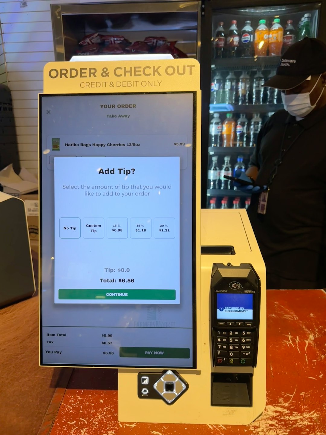 a checkout counter with a cell phone on it mobile checkout form simplified ecommerce checkout user typing phone payment