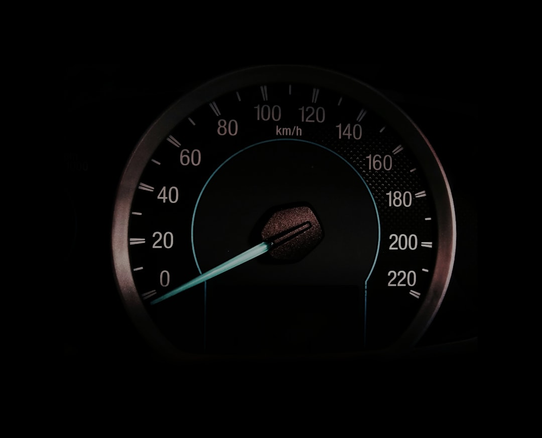 a close up of a speedometer in the dark database performance chart speed gauge server monitoring dashboard