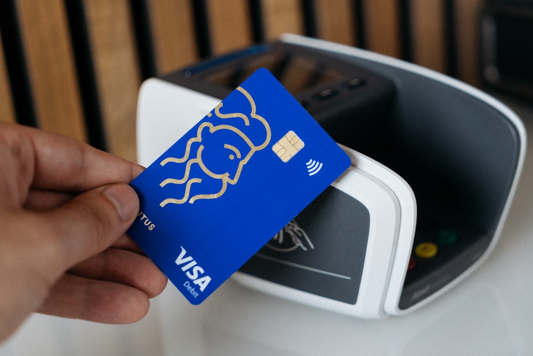 a person is holding a blue credit card credit card sharing credit card financial partnership