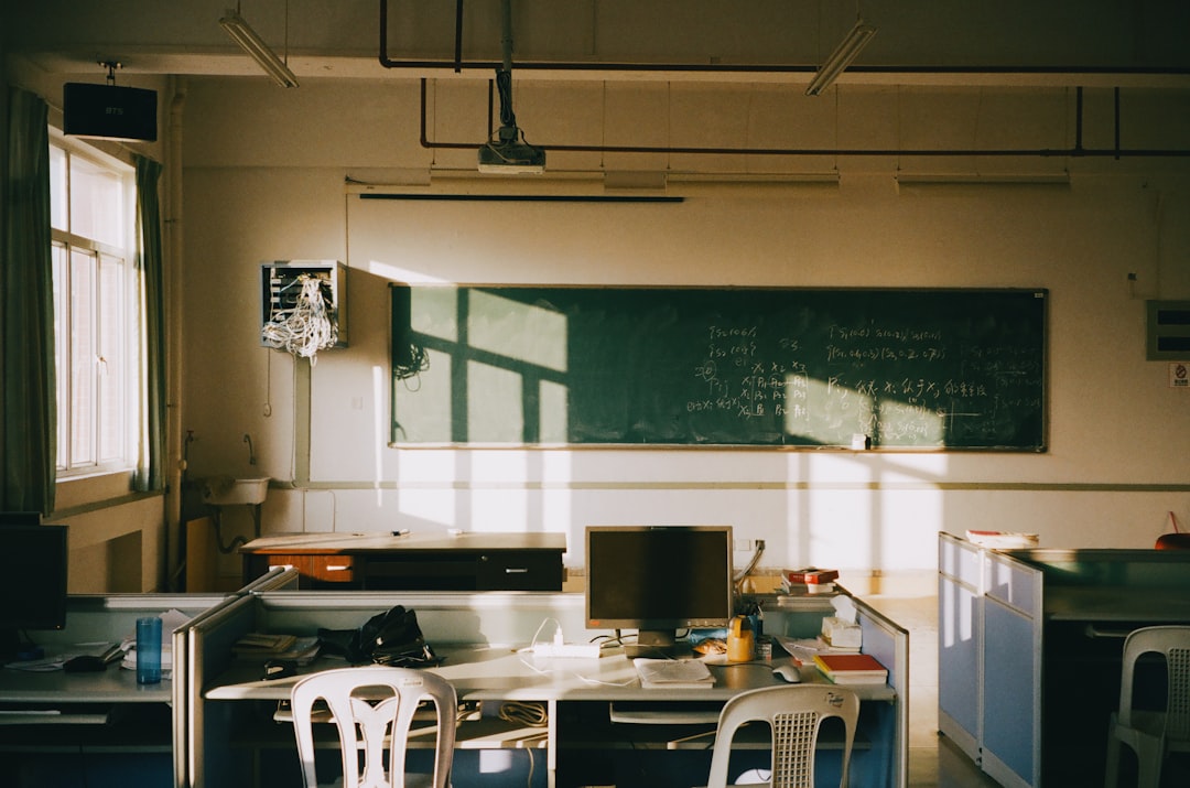 sunlight streams into an empty classroom with desks ai teacher classroom productivity tools