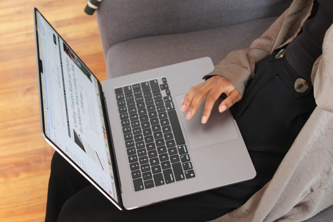 a person sitting on a couch using a laptop computer person frustrated with laptop login error screen home office setup