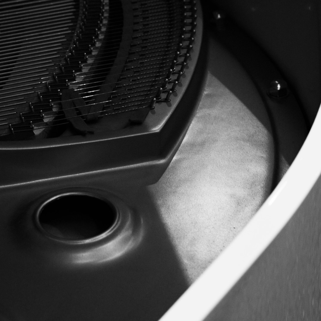 close up of a black metal grill with a circular opening pc interior dust buildup cooling fans cpu heatsink