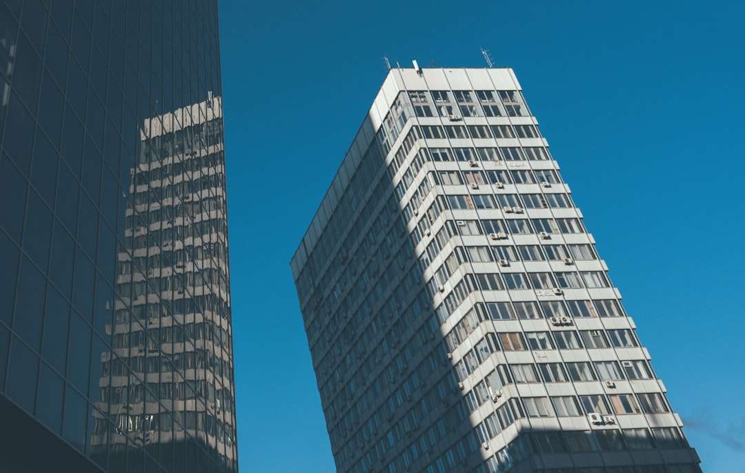 skyscraper and its reflection under a clear blue sky rounded corner image before after comparison hover effect