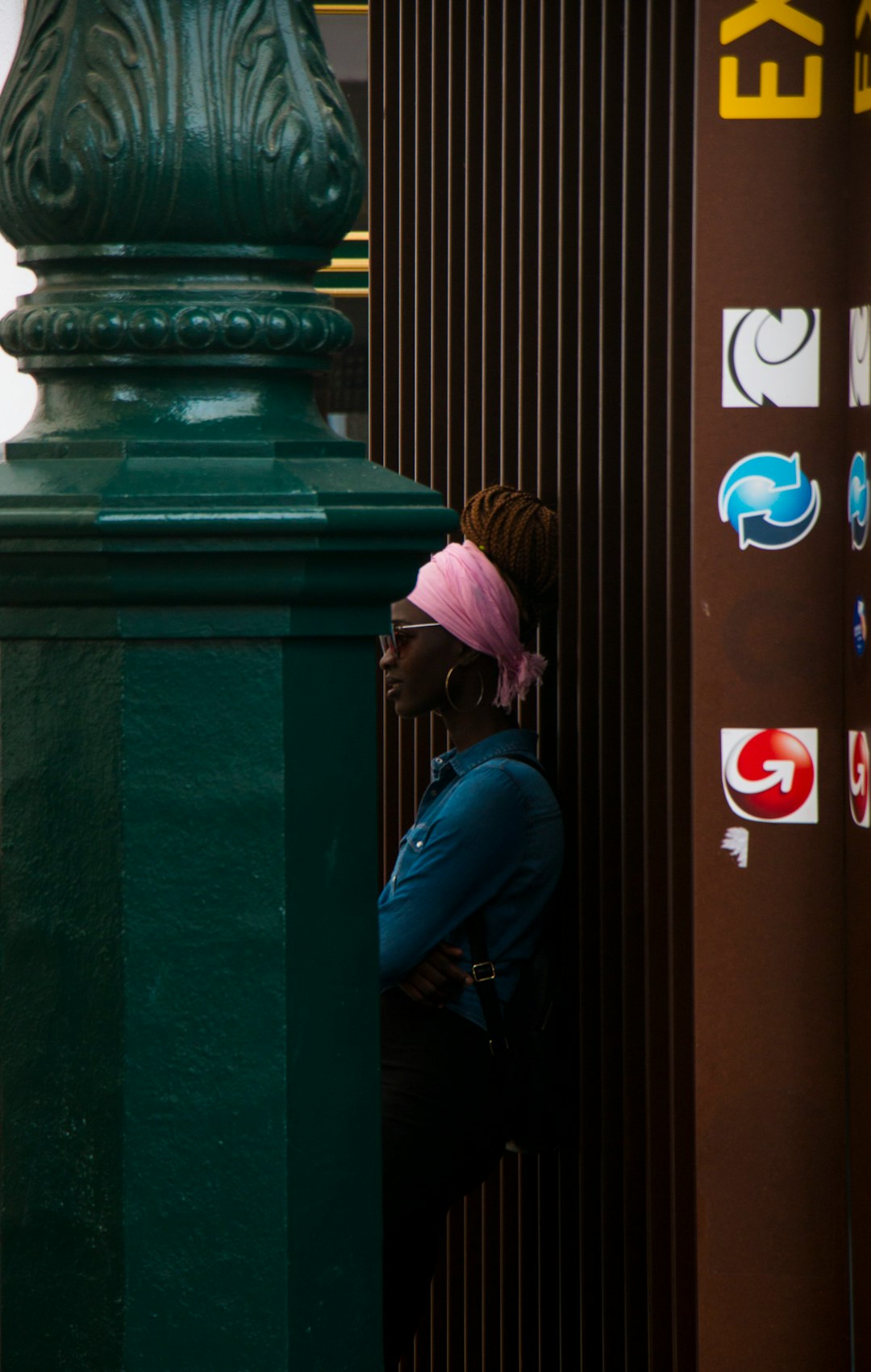 woman leaning on brown wall comparison chart on smartphone screen social media apps icons notification symbols