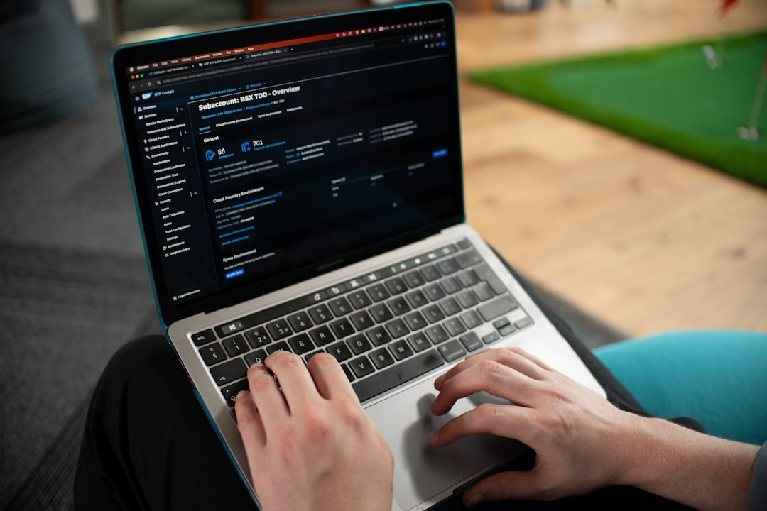 hands typing on a laptop computer screen backend dashboard analytics database management screen cloud infrastructure panel